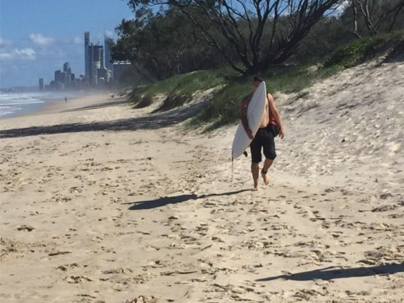 Surfer Walking Up Spit Beach